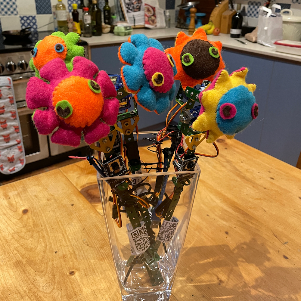 A bunch of felt and ESP32cam flowers in a vase in a kitchen